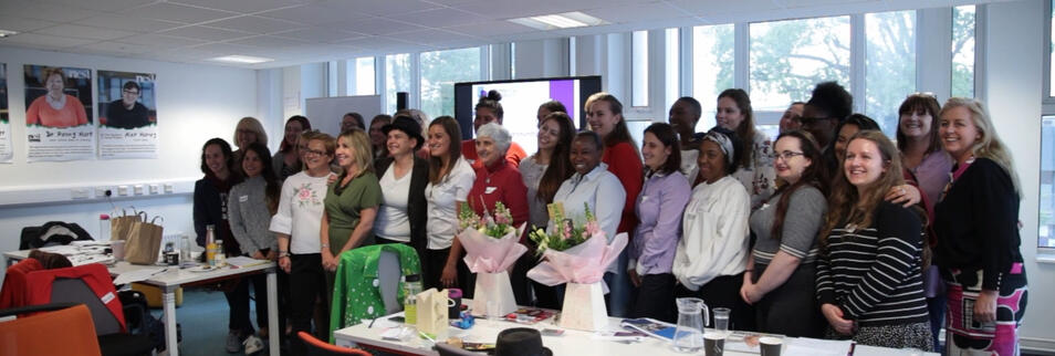 Business women pose for a picture